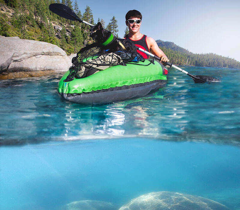 person kayaking lake tahoe with their dog 